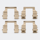 Four stamped metal brake pad clips arranged in two rows